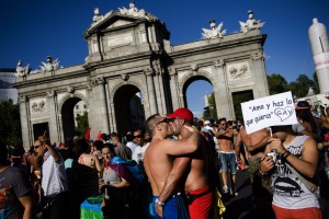 Revelers participate in the Gay Pride parade in Madrid, Saturday, June 30, 2012. Banner reads 'Love and do whatever you feel like. Gay'.